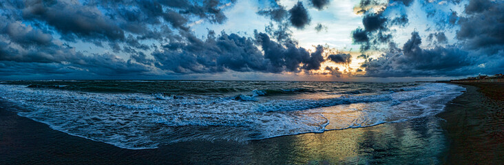 Wonderful and imperdible panoramic view at sunset sea, fantastic stormy sky with cumulus clouds and...
