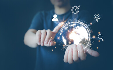 Hand holding a holographic globe. Future world concept of big data, link to online communication, cloud storage, internet world and social media. Hold the world in hand.