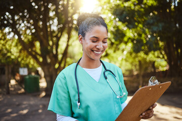 Woman, nurse and smile looking at clipboard in healthcare, medical or prescription in outdoor park....