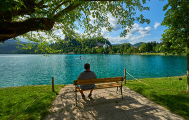 Man on the bench at Bled lake promenade, Slovenia
