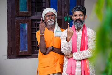indian man showing finger after voting. voting sign in india