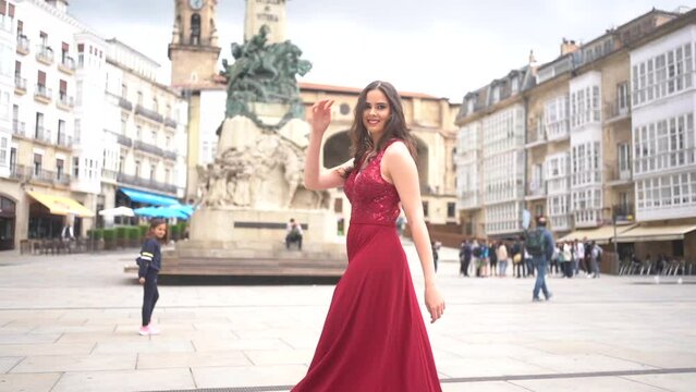 Caucasian model with red dress visiting the city of Vitoria, Araba. Spain