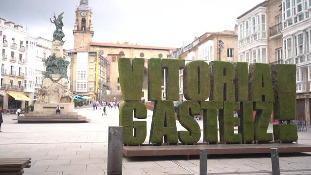 Caucasian model with red dress presenting the city of Vitoria Gasteiz, Araba. Spain