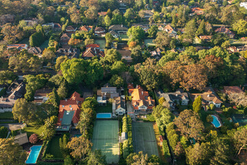 Aerial view of upmarket houses with private gardens, pools and tennis courts on Sydney's leafy...