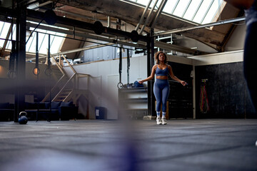 Young woman skipping in a gym