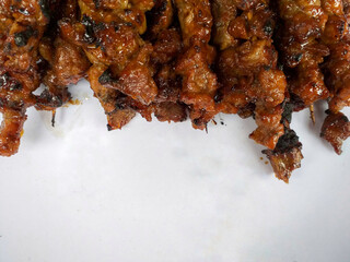 Abstract background of a bunch of cooked lamb satay with copy space area on the bottom