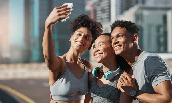 Phone, selfie and fitness with a man and woman sports group taking a photograph together in the city. Health, teamwork and mobile with an athlete group posing for a picture in an urban town
