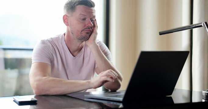 Boring man and stupid work man looks at laptop