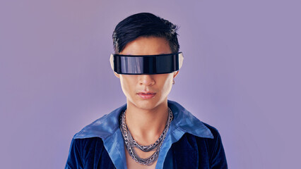 Face, cyberpunk and virtual reality with asian man in futuristic eyewear in studio on purple background for metaverse or 3d fashion. Portrait, robot and future of young male in glasses for fantasy ai