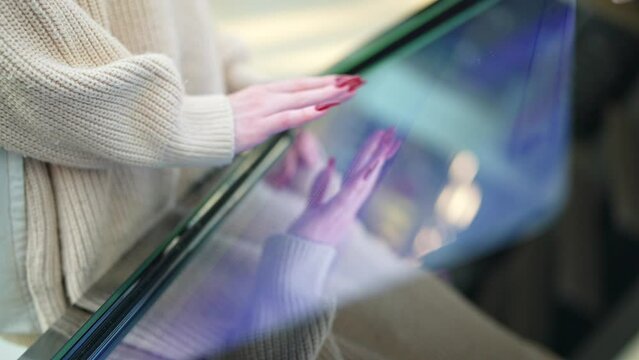 Interactive map of the shopping center, floor plan. female hands move across the screen, moving the plan. touchscreen