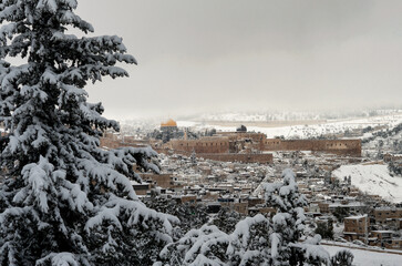 Fototapeta na wymiar View of the Old City of Jerusalem, the Temple Mount and Dome of the Rock mosque following a rare winter snow storm in Jeruslaem,