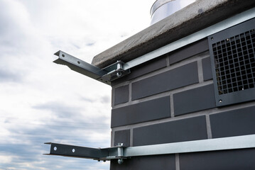 Chimney holder for mounting a satellite dish on the chimney, close-up view.