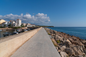 Fototapeta na wymiar Harbour wall L'Ametlla de Mar Tarragona Spain Costa Dorada north of L`ampolla Mediterranean sea