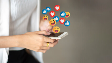 The concept of social medias and technology.Close up hands using smartphone addiction to technology trends following and chatting with icon on social networks. surrounded by many icons, likes, hearts