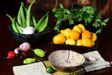 pequi fruit typical Brazilian food, okra seasonings, salad and melted cheese au gratin on blurred background