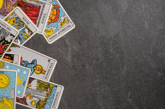 Esoteric tarot cards for fortune telling on a gray stone background