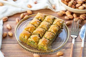 Pistachio baklava. Close-up baklava isolated on wood background. Mediterranean cuisine delicacies