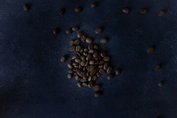 Coffee beans on a dark background, roasted coffee beans, or seeds