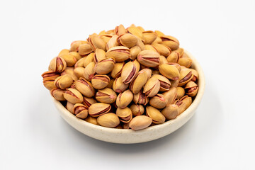 Pistachio. Pistachios in bowl on white background. close up