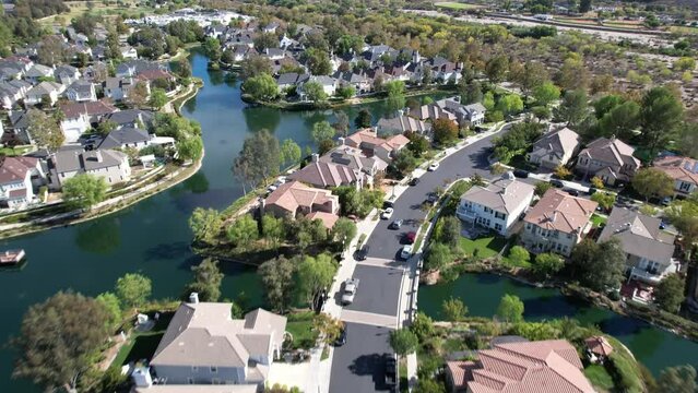 Residential homes in the Bridgeport waterfront neighborhood of lsland Road in Valencia, Santa Clarita, California - aerial flyover