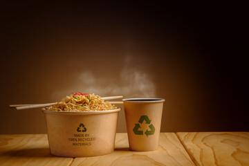 Recycled Packaging Concept. Recycled Bow with Hot Boiled Instant Noodles and Cup of Coffee on the...