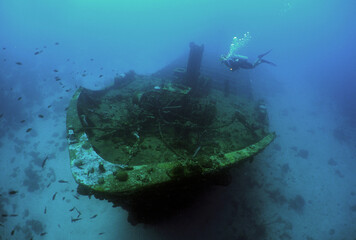 beautiful shipwreck and a diver in the crystal clear waters of the island of Curacao in the caribbean sea