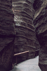 wooden mountain trail between rocks