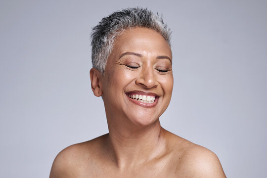 Happy senior model, beauty and makeup face for cosmetics, health and skincare by studio backdrop. Elderly black woman, skin wellness and radiant cosmetic glow, anti aging and smile by grey background