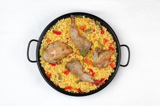 Rice in paella with quail meat