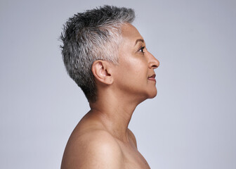 Mature woman, face and skincare glow on gray studio background in plastic surgery, body dermatology...
