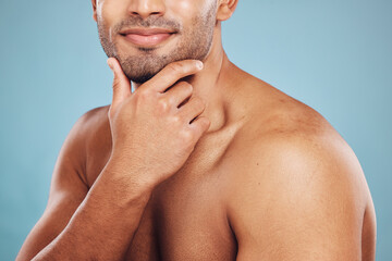 Hand, skincare and beauty with a man model in studio on a blue background thinking about grooming....