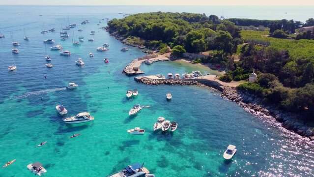 Flying around the port of Saint Honorat island part of the Iles de L&eacute;rins, next to Cannes in south of France. Clear watter of the mediterranean sea, little boats, wineyards and monastery on the island
