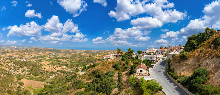 Republic of Cyprus . Pissouri Resort. Cypriot road at foot mountain. Regions of island of Cyprus. Top view of Mediterranean village. Panorama of city of Pissouri. Concept renting apartments in Cyprus
