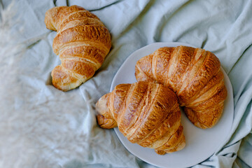 Delicious croissant a cup of coffee and French breakfast in bed