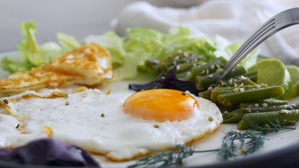 Breakfast on keto diet is high in fat and protein. Proper nutrition in morning is the key to health and energy for the whole day. Fried eggs with stewed vegetables and herbs are tasty and nutritious.
