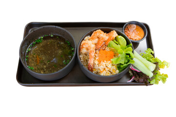 CCrab Paste fried Rice with broth isolated on white background. Prepared served in black tiled tray. Mixture of delicious yellow crab roe and big shrimp. Garnish dish with vegetable Salad, cucumber.