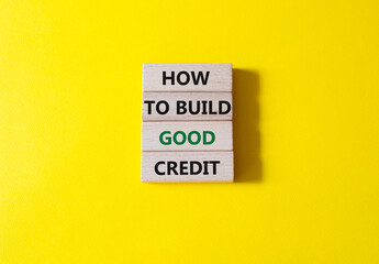 How to build good credit symbol. Concept words How to build good credit on wooden blocks. Beautiful yellow background. Business and How to build good credit concept. Copy space.