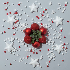 Creative layout made of christmas red baubles and other elements. Minimal flat lay concept.