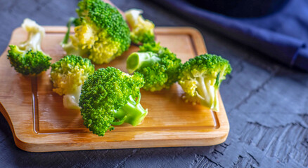Close-up of  green fresh vegetable broccoli. Fresh green broccoli on wooden table.Broccoli vegetable is full of health .Vegetables for diet and healthy eating.Organic food.