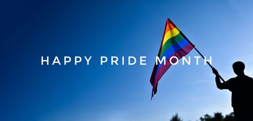 'HAPPY PRiDE MONTH' on bluesky and rainbow flags background, concept for lgbtq+ celebrations in...