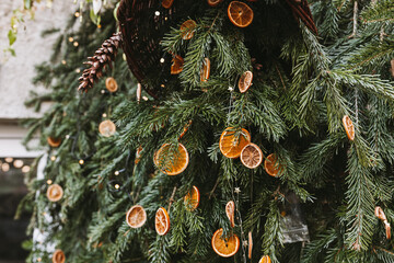DIY handmade natural decoration made of orange slice on Christmas tree