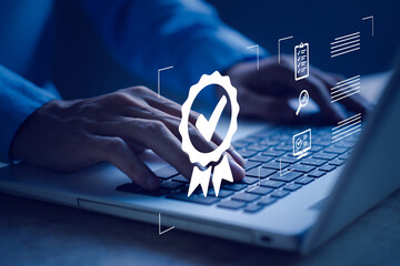 Businessman with sign of top service via notebook (Laptop). ISO certification, Guarantee, Quality...