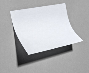 A paper note sticking on wall with shadow.