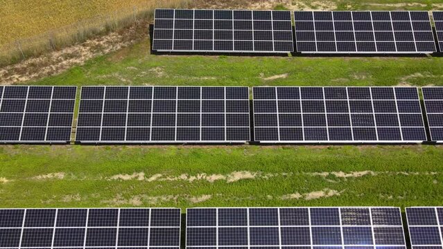 Aerial view, massive Solar panel farm on the field, alternative energy