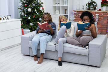 Girls focused while reading a book on Christmas Day.