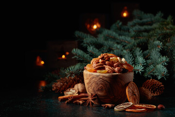Christmas still-life with dried fruits, nuts, and burning candles.
