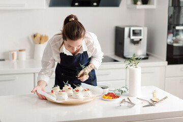 Confectioner prepares delicious desserts for sale. High quality photo