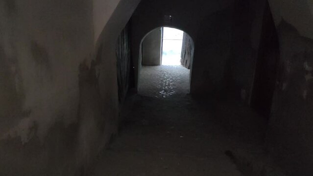 Dark wide walled tunnel in an old town