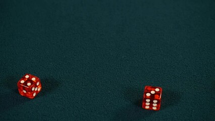 Casino player rolls seven on dice playing craps, rolling four and three with pair of red dice on green casino gaming table, Slow motion  - Powered by Adobe