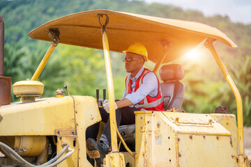 Construction worker are driving bulldozer at construction site.
